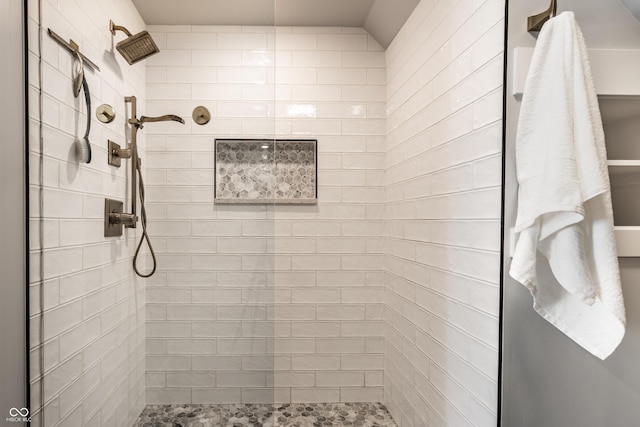 bathroom with a tile shower