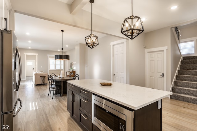 kitchen featuring stainless steel appliances, hanging light fixtures, recessed lighting, and light wood finished floors