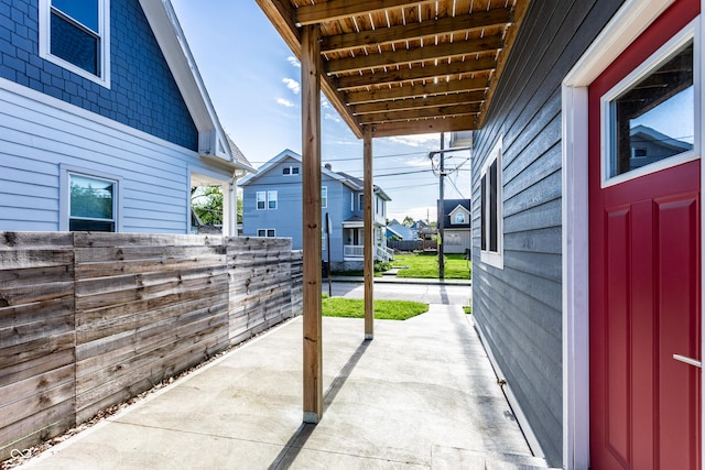 view of patio / terrace featuring fence and a residential view