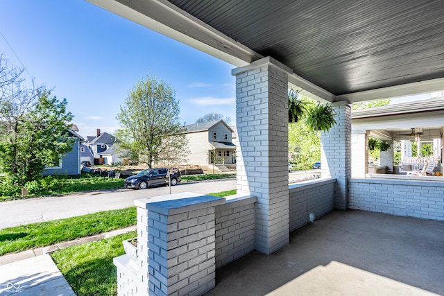 view of patio / terrace with a porch and a residential view