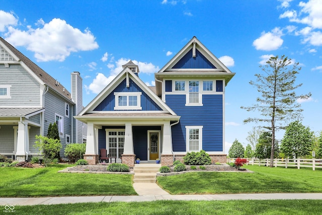 craftsman-style house featuring brick siding, covered porch, and board and batten siding