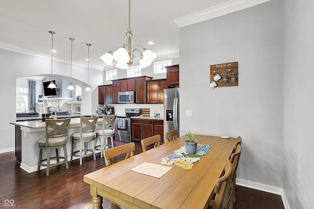 dining area with a chandelier, ornamental molding, baseboards, arched walkways, and dark wood-type flooring