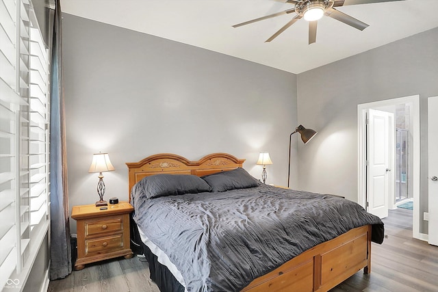 bedroom with wood finished floors, a ceiling fan, and baseboards