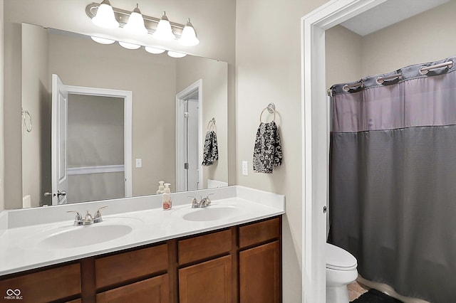 bathroom featuring double vanity, toilet, and a shower with shower curtain