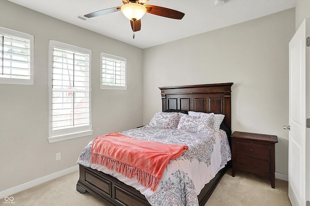 bedroom with light carpet, baseboards, and ceiling fan