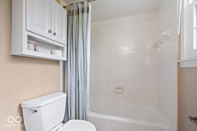 bathroom with shower / bath combo and toilet