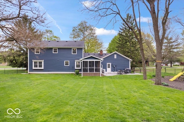 back of property featuring fence, a yard, a patio, and a sunroom