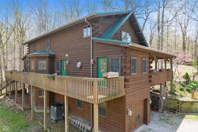 4840 N Templin Rd, Martinsville, IN 46151 - rear view of house featuring log siding, an attached garage, a deck, cooling unit, and driveway