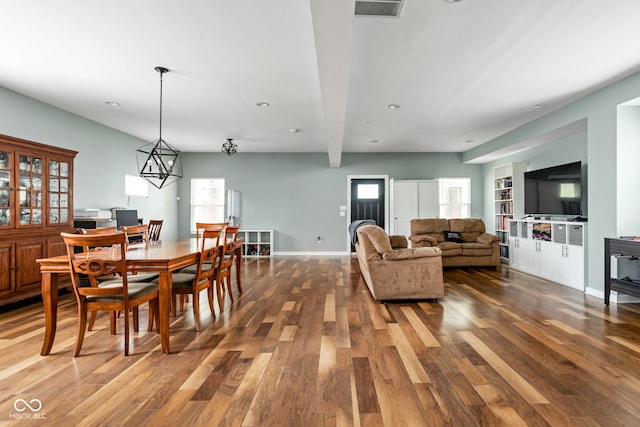 dining room with beam ceiling, recessed lighting, baseboards, wood finished floors, and visible vents