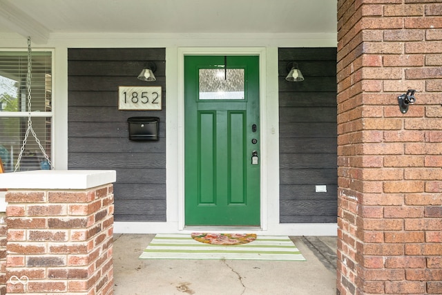view of exterior entry with a porch