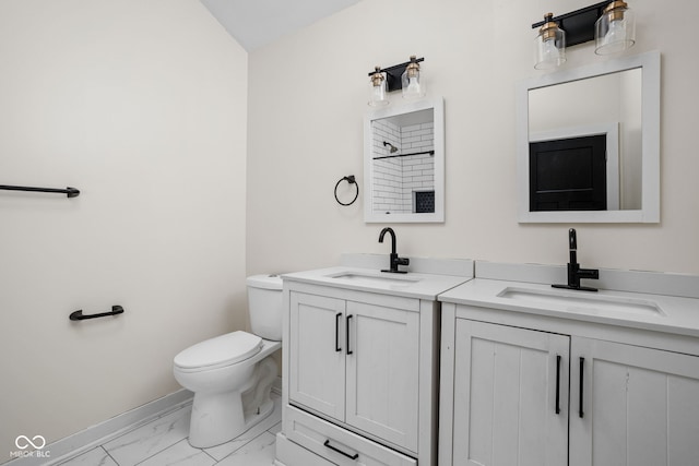 bathroom featuring walk in shower, vanity, toilet, marble finish floor, and baseboards
