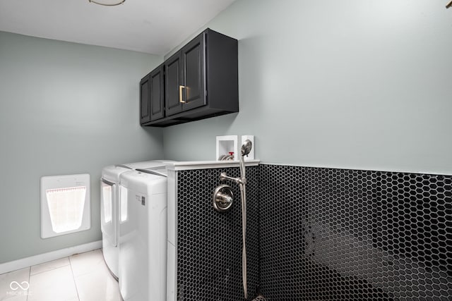laundry area with light tile patterned floors and washer and clothes dryer
