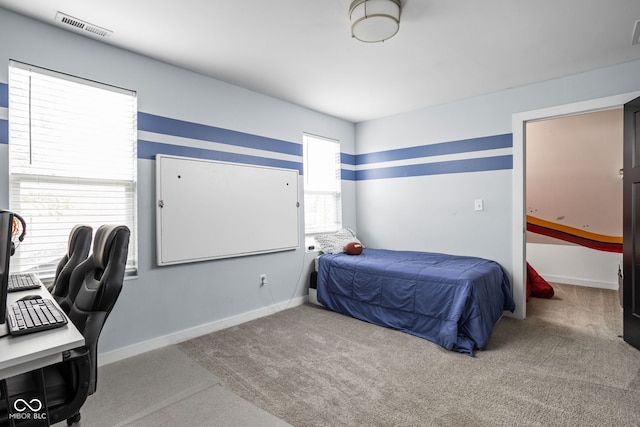carpeted bedroom featuring visible vents and baseboards