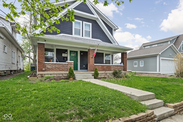 view of front of property with a porch, brick siding, a garage, and a front lawn