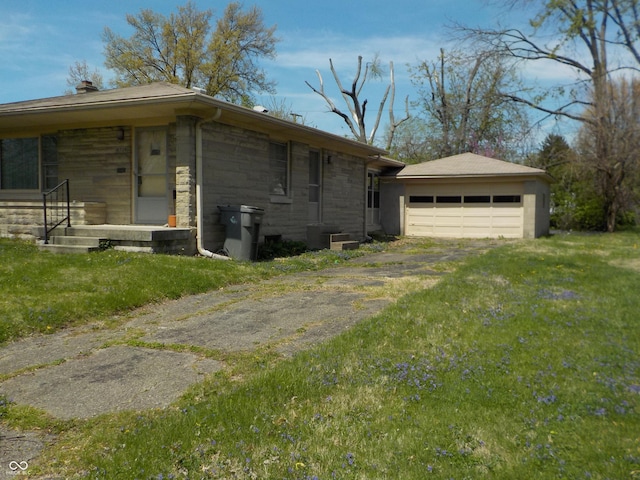 view of side of home featuring a yard, driveway, a chimney, and stone siding