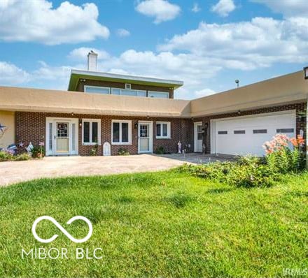 1391 S River Rd, Covington, IN 47932 - view of front of property with a garage and a front lawn