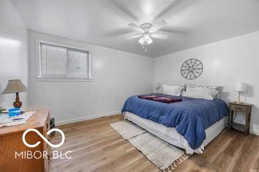 1391 S River Rd, Covington, IN 47932 - bedroom with baseboards, ceiling fan, and wood finished floors