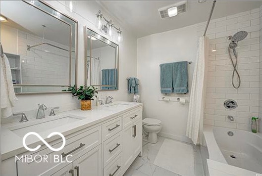 1391 S River Rd, Covington, IN 47932 - bathroom with a sink, double vanity, toilet, shower / bathtub combination with curtain, and visible vents