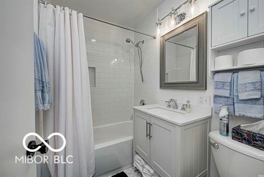 1391 S River Rd, Covington, IN 47932 - bathroom featuring toilet, shower / bath combination with curtain, and vanity