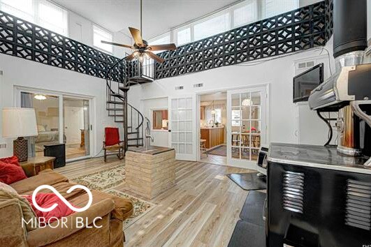 1391 S River Rd, Covington, IN 47932 - living area with plenty of natural light, french doors, wood finished floors, and a towering ceiling