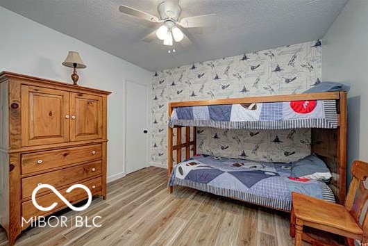 1391 S River Rd, Covington, IN 47932 - bedroom featuring a ceiling fan, a textured ceiling, and light wood-style floors