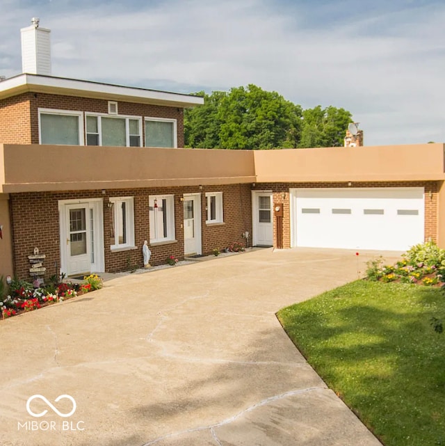 1391 S River Rd, Covington, IN 47932 - view of front of home featuring brick siding, a chimney, and concrete driveway