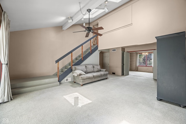 2513 Grandma Barnes Rd, Nashville, IN 47448 - unfurnished living room featuring visible vents, carpet floors, beamed ceiling, ceiling fan, and high vaulted ceiling