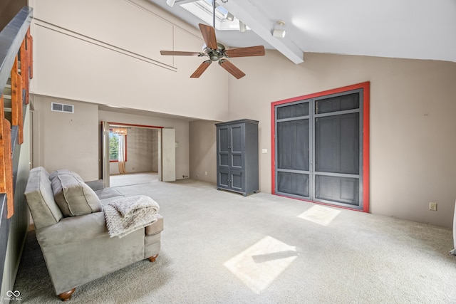 2513 Grandma Barnes Rd, Nashville, IN 47448 - living area with visible vents, beamed ceiling, high vaulted ceiling, light colored carpet, and a ceiling fan