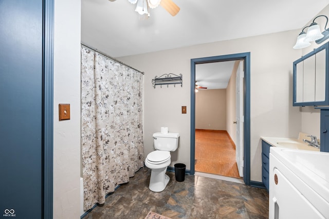 2513 Grandma Barnes Rd, Nashville, IN 47448 - full bathroom featuring ceiling fan, vanity, toilet, stone finish floor, and washer / dryer