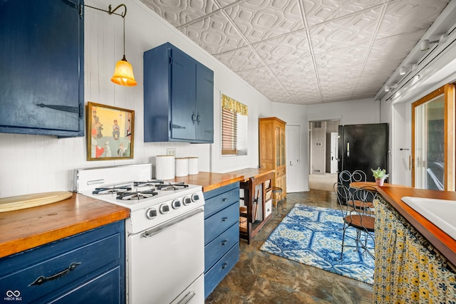 2513 Grandma Barnes Rd, Nashville, IN 47448 - kitchen with gas range gas stove, blue cabinetry, and butcher block counters