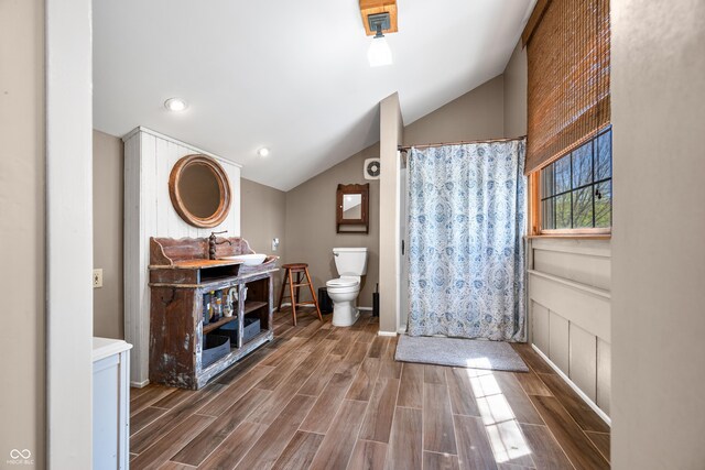2513 Grandma Barnes Rd, Nashville, IN 47448 - bathroom with vanity, wood finished floors, vaulted ceiling, and toilet