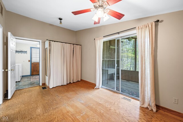 2513 Grandma Barnes Rd, Nashville, IN 47448 - unfurnished bedroom featuring access to outside, ceiling fan, visible vents, and light wood-style floors