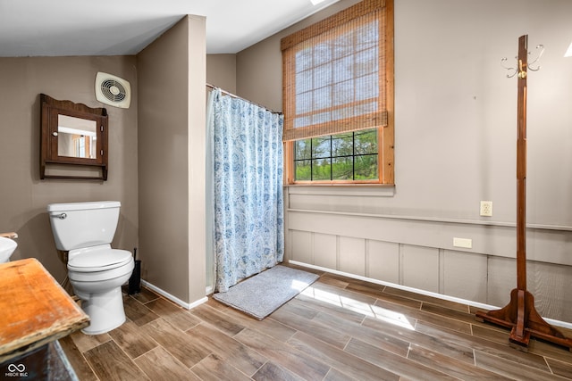2513 Grandma Barnes Rd, Nashville, IN 47448 - bathroom with visible vents, a shower with shower curtain, wood finished floors, and toilet