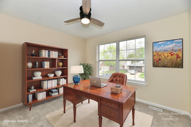 office area featuring baseboards, a ceiling fan, light colored carpet, and visible vents