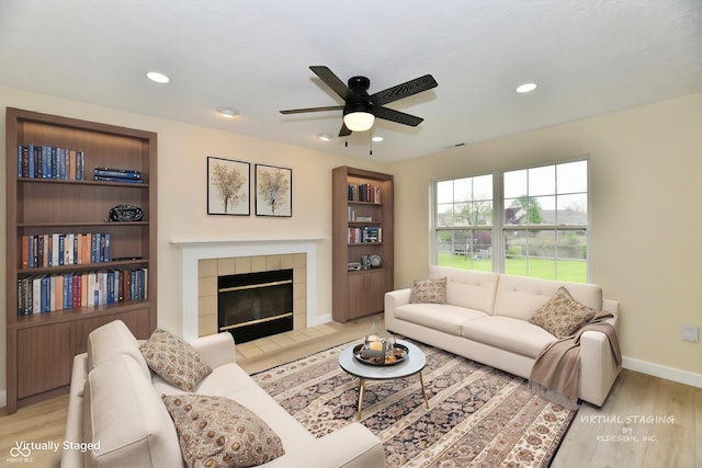 living area with a ceiling fan, baseboards, recessed lighting, and light wood-style floors
