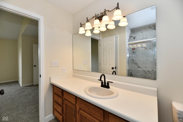 full bathroom featuring vanity, baseboards, a stall shower, and toilet