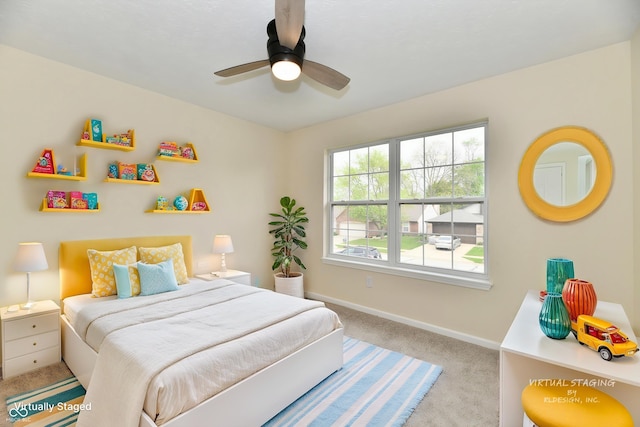 carpeted bedroom featuring baseboards and ceiling fan