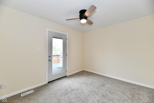unfurnished room featuring baseboards, ceiling fan, carpet flooring, and visible vents