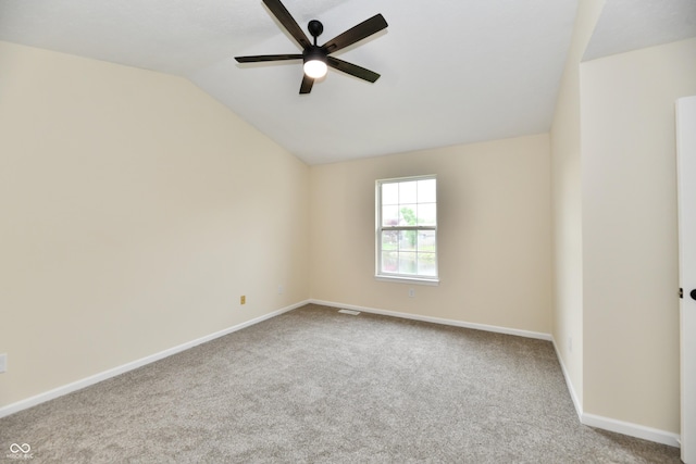 carpeted empty room featuring baseboards, ceiling fan, and lofted ceiling