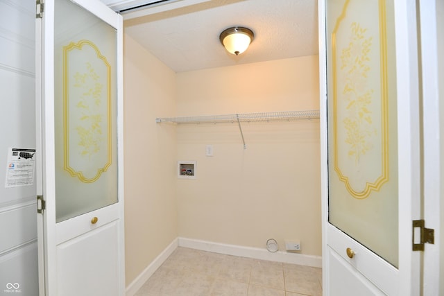 laundry area featuring light tile patterned floors, washer hookup, baseboards, and laundry area