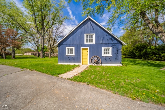 bungalow-style home with a front yard