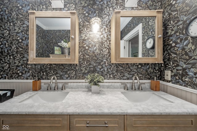 bathroom featuring double vanity, a sink, and wallpapered walls