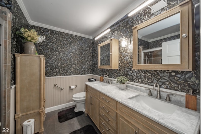 bathroom featuring crown molding, wallpapered walls, and a sink