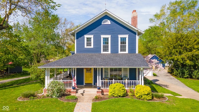 farmhouse with a front yard, roof with shingles, covered porch, and a chimney