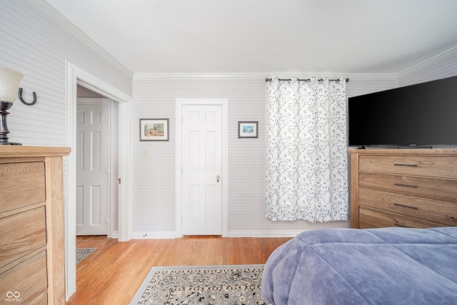 bedroom featuring baseboards, ornamental molding, and light wood-style flooring