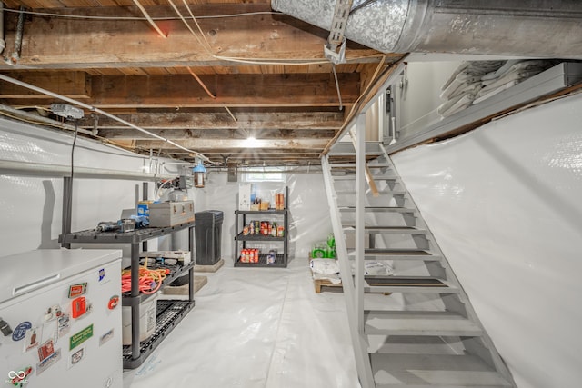 below grade area featuring white refrigerator and stairs