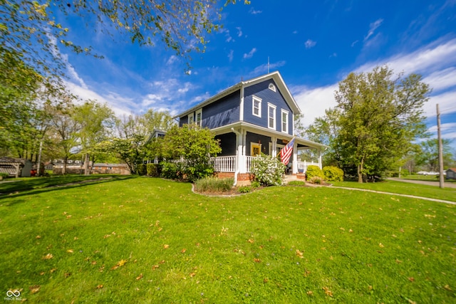 view of side of home featuring a yard and covered porch