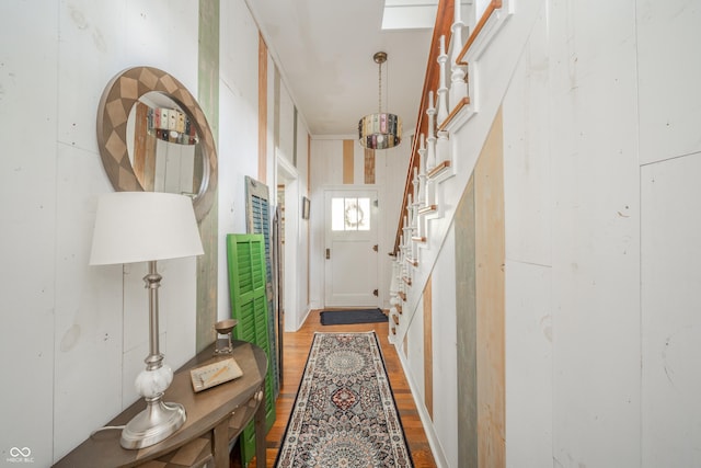 hall featuring light wood-style flooring and stairs