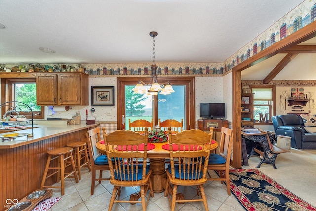 7020 N 375 E, Lebanon, IN 46052 - dining area with an inviting chandelier, wallpapered walls, and light tile patterned flooring