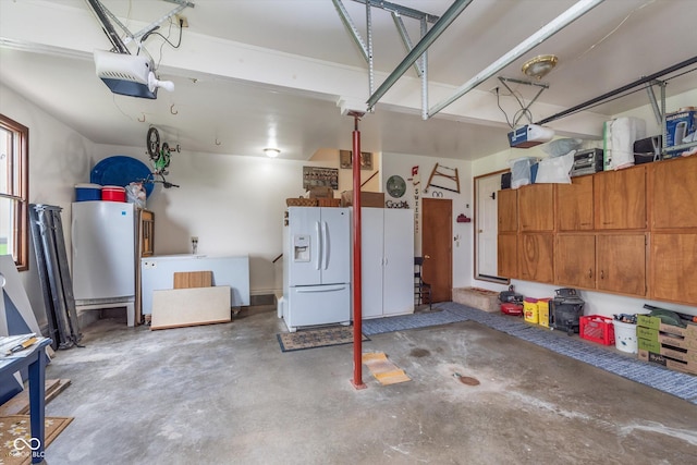 7020 N 375 E, Lebanon, IN 46052 - garage featuring a garage door opener and white refrigerator with ice dispenser